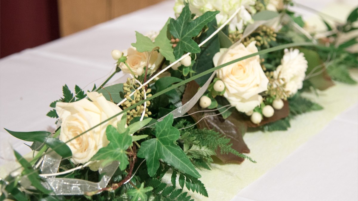 Gesteck als Tischschmuck mit weißen Rosen